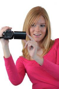 Woman holding compact video camera